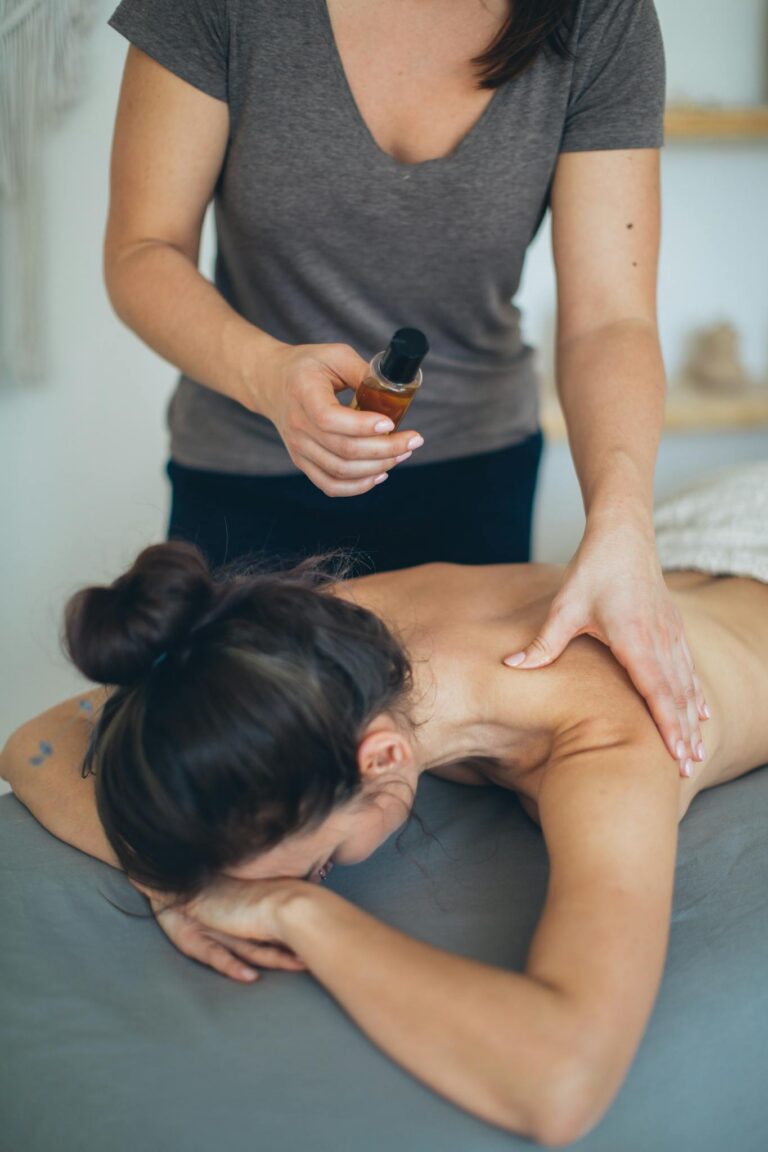 A woman receives a soothing back massage with oil for relaxation and wellness in a spa setting.
